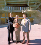 Richard Bowers, Lee Rose, and John Lott Brown pose with basketball in front of Sun Dome by University of South Florida