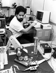 Researcher working with robotic arm, c.1980 by University of South Florida