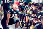 Football players on bench by University of South Florida
