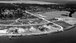 Aerial view: Waterfront houses, some with docks; more houses, trees in background by Francis G. Wagner and Nelson Poynter Memorial Library