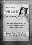 Bulletin board sign "We make all our prints on Velox because Velox gives the best results"