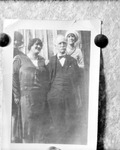 Bulletin board photo of photo of three women and man standing