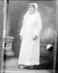 Bulletin board photo of photo of woman wearing hood, column at side