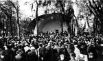 Esther Stewart Kahn postcard showing Williams Park; a concert in the bandshell with a large audience; writing on back: "This shows the band shell and some of the crowd who go to hear them. The band is playing the Star Spangled Banner and that is the reason the people are standing." by Francis G. Wagner and Nelson Poynter Memorial Library