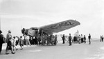 Ford Tri-Motor NC-5492 "Hi-Way" parked, with crowd of people around it. Names on the front: Perry, Hutton, Edward, Hamilton by Francis G. Wagner and Nelson Poynter Memorial Library
