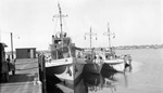 Coast Guard vessels docked, car and people visible by Francis G. Wagner and Nelson Poynter Memorial Library