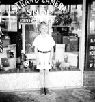 Dick standing in front of Strand Camera Shop by Francis G. Wagner and Nelson Poynter Memorial Library