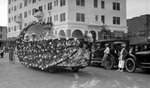 Ohio parade float, cars, bicyclist in front of Ponce de Leon Hotel, fish market; spectators include people watching from hotel balcony by Francis G. Wagner and Nelson Poynter Memorial Library