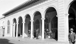 Open Air Post Office, people around tables (mostly men) by Francis G. Wagner and Nelson Poynter Memorial Library