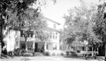 Park House with people on front porch and building next door by Francis G. Wagner and Nelson Poynter Memorial Library