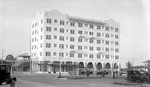 Ponce de Leon Hotel and cars (parked) plus awning store and men walking by Francis G. Wagner and Nelson Poynter Memorial Library
