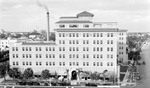 Soreno Hotel with smokestack, cars; buildings to the northwest by Francis G. Wagner and Nelson Poynter Memorial Library
