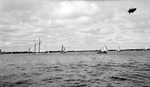 Several sailboats and other boats on Tampa Bay with land in background and the Goodyear Blimp above by Francis G. Wagner and Nelson Poynter Memorial Library