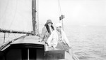 Irma (in back) and Fran (Mrs. Elon) Robison in hats and coats on sailboat, other boat in water in background by Francis G. Wagner and Nelson Poynter Memorial Library