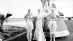 Three women posed in front of a parade float; car in background by Francis G. Wagner and Nelson Poynter Memorial Library