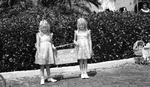 Two girls: "The Sunshine Twins" next to a doll carriage with sign, "St. Pete Future Housewife."; probably taken at the Vinoy Hotel by Francis G. Wagner and Nelson Poynter Memorial Library