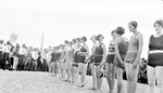 Young women in bathing suits standing in a line with group of boy scouts; sign, "Enjoy Outdoor Sports Every Day." by Francis G. Wagner and Nelson Poynter Memorial Library