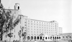 Vinoy Hotel with yard and couple walking by Francis G. Wagner and Nelson Poynter Memorial Library