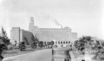 Vinoy Hotel and Bayshore Drive with parked cars and people, plus smokestack by Francis G. Wagner and Nelson Poynter Memorial Library