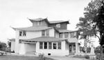 Unknown house, large three-story Japanese-style house with person sitting in rocking chair on open porch by Francis G. Wagner and Nelson Poynter Memorial Library